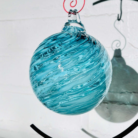 AquaCeledon Optical Glass hand-blown blue and teal swirled glass ornament with hanging loop and shadow on white background