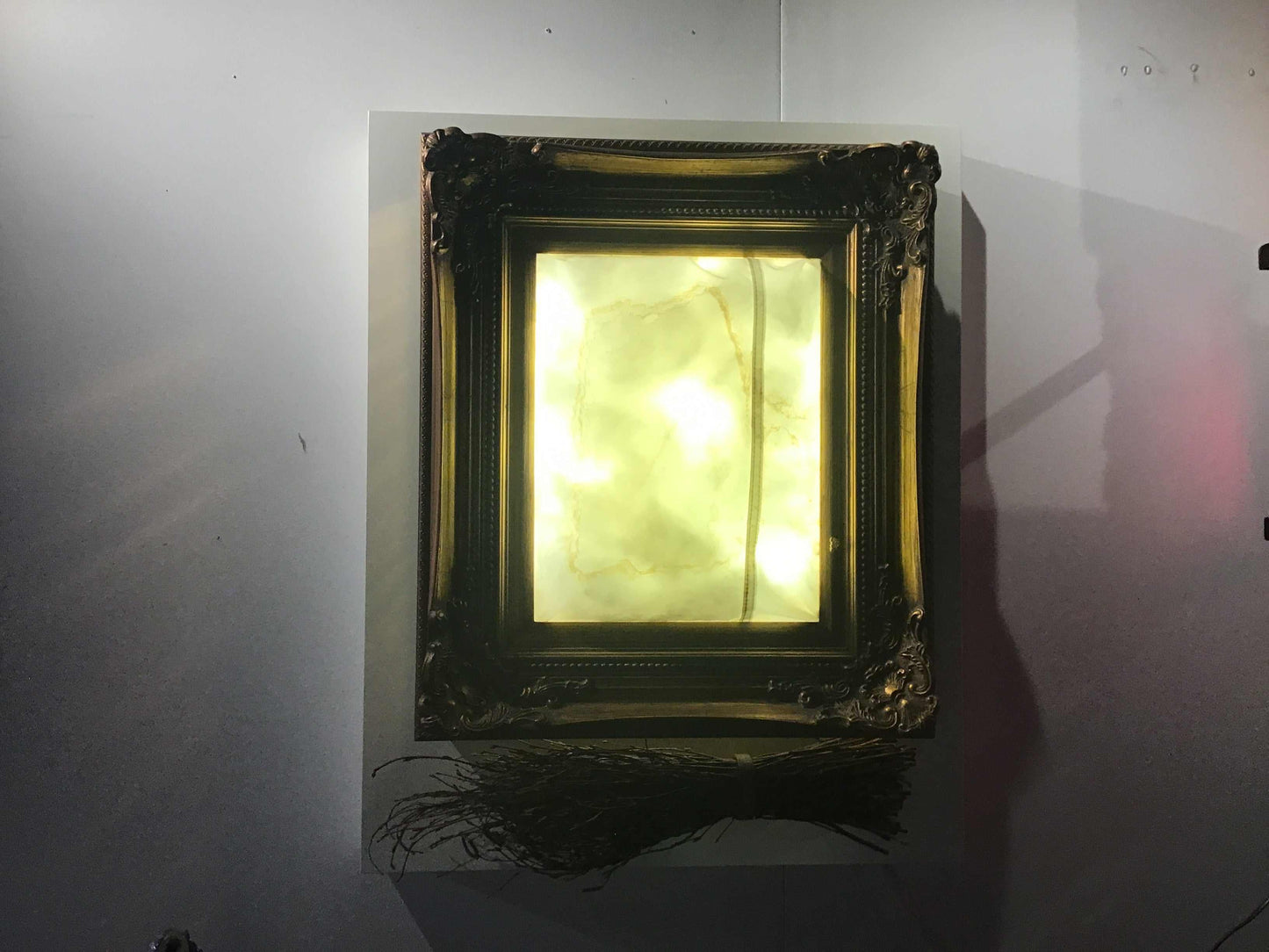 Illuminated vintage frame with glowing yellow neon light and branches at the base, Branches Neon artwork