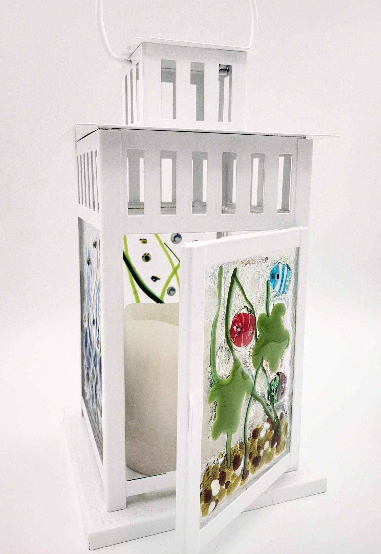 White decorative lantern with colorful fused glass panels featuring abstract nature-inspired designs