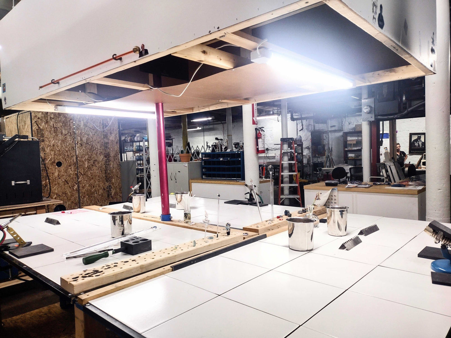 Glassworking studio setup with torches and equipment for making glass swans in a beginner flameworking class.