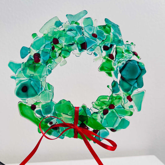 Fused Glass Holiday Wreath with green and blue glass pieces and red ribbon bow decoration