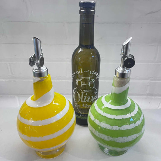Set of 2 colorful oil and vinegar drizzler bottles with stainless steel spouts and a decorative olive oil bottle.
