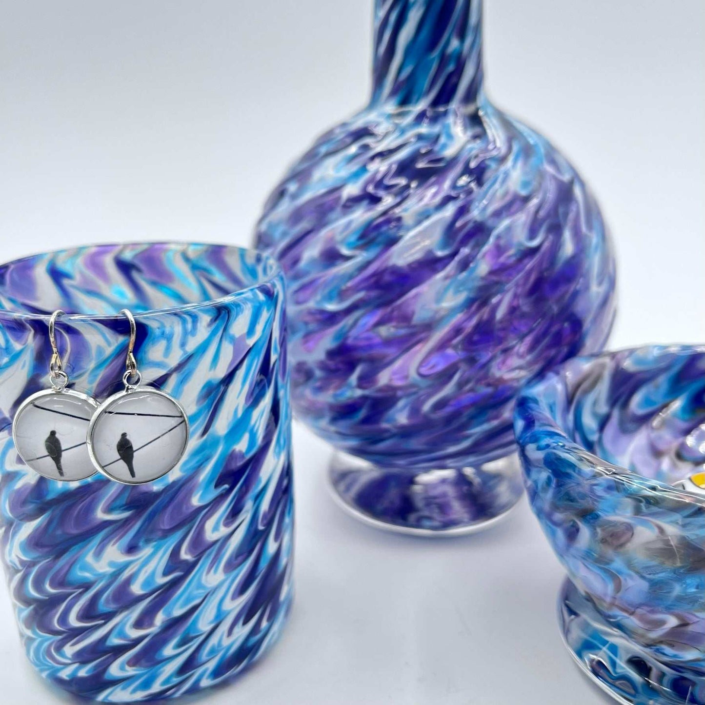 Handmade marbled glass vanity set with hyacinth and aqua swirls, including soap dispenser, bowl, and glass.