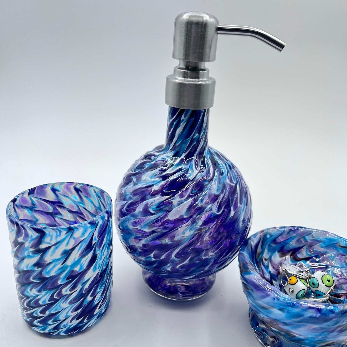 Handmade marbled glass vanity set in hyacinth and aqua with soap dispenser, bowl, and glass