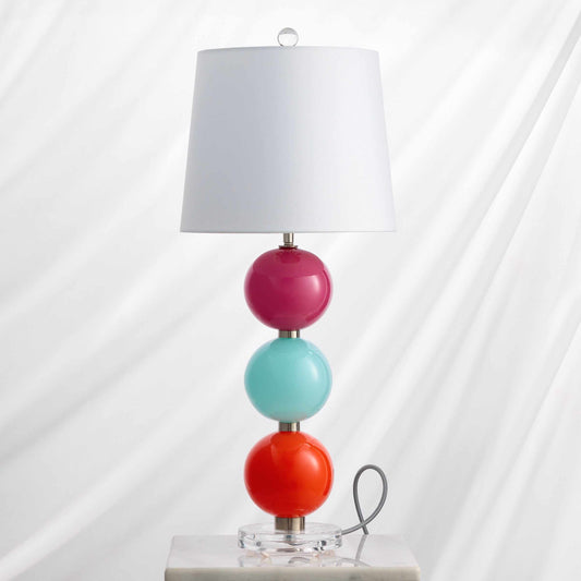 Nina Table Lamp with three colorful stacked glass globes, white fabric shade, and clear acrylic base