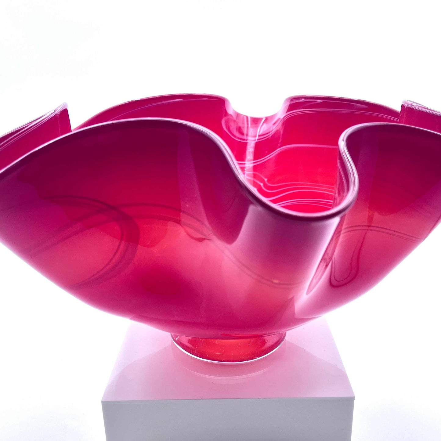 Pink twisted glass bowl with fluid, organic curves made from hot glass