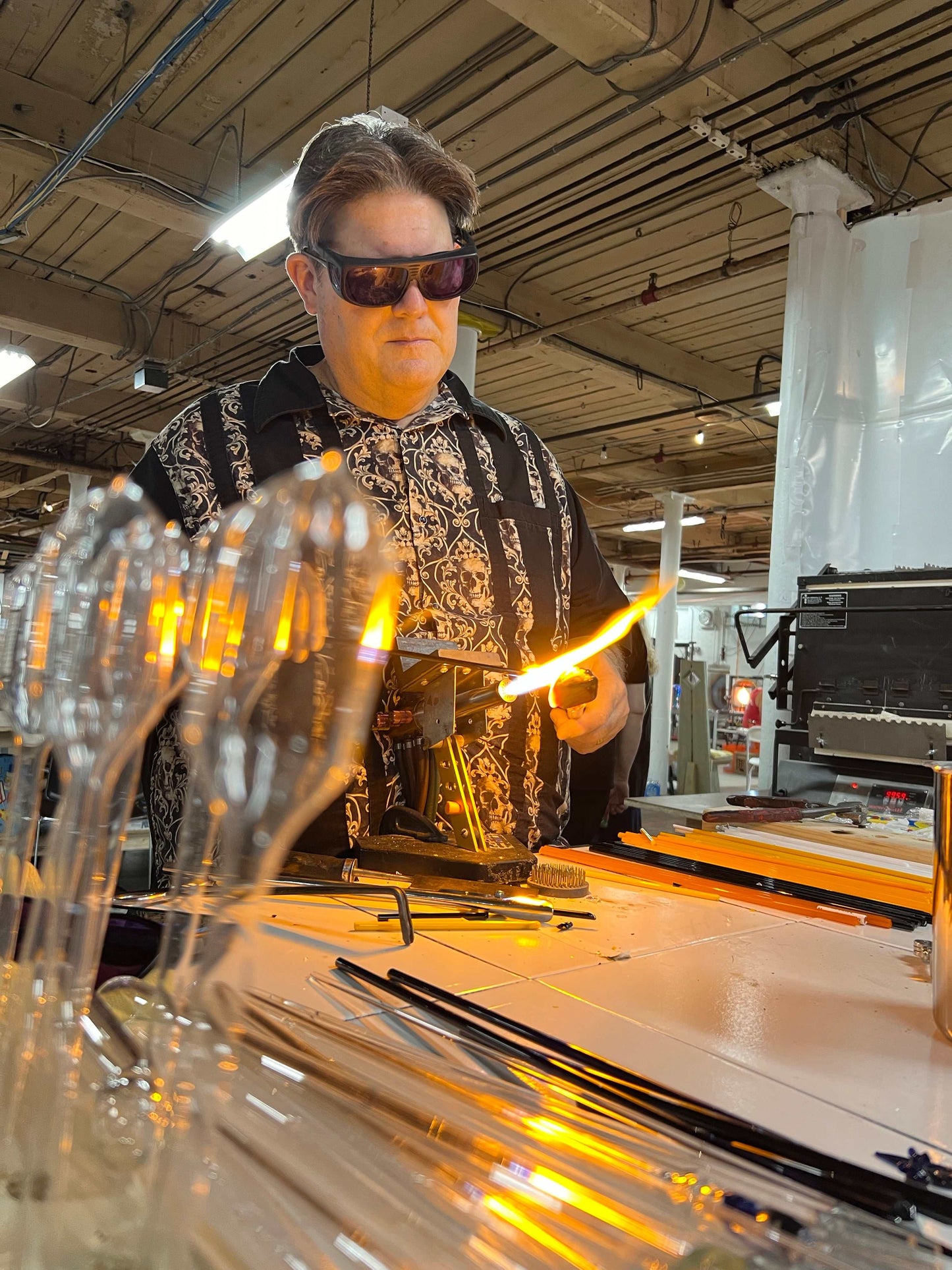 Man using 20" glory hole rental for glass annealing and shaping in workshop