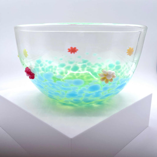 Clear blown glass flower bowl with colorful hand-crafted floral accents and a celadon teal base