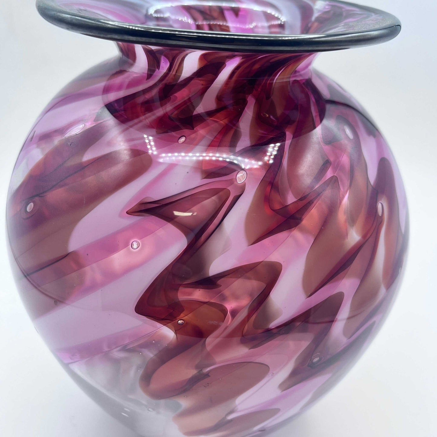 Hand blown lava vase with swirling purple and brown patterns and a flared rim, 9x7x5 inches, signed and unique.