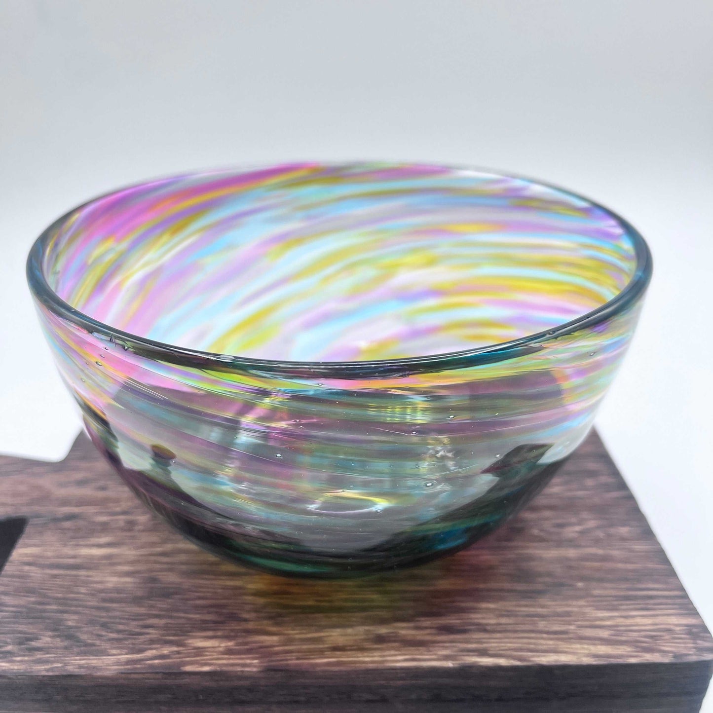 Hand-blown Rainbow Twist Serving Bowl with vibrant ruby, gold, purple, and blue swirls, 6x3 inches, twisting organic glass design.