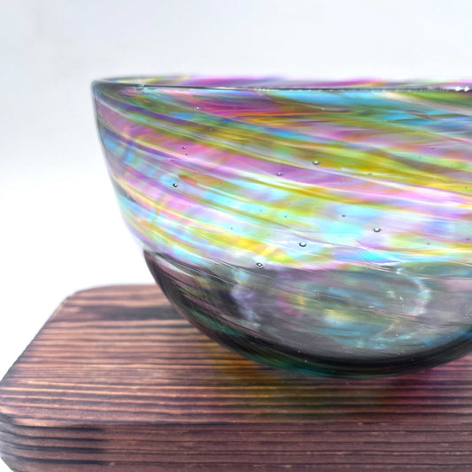 Hand-blown Rainbow Twist Serving Bowl with vibrant rainbow gradient and twisted design on wooden surface