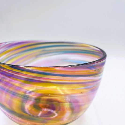Hand-blown Sunset Twist Serving Bowl with warm orange, gold, and red gradient and twisting organic glass design.