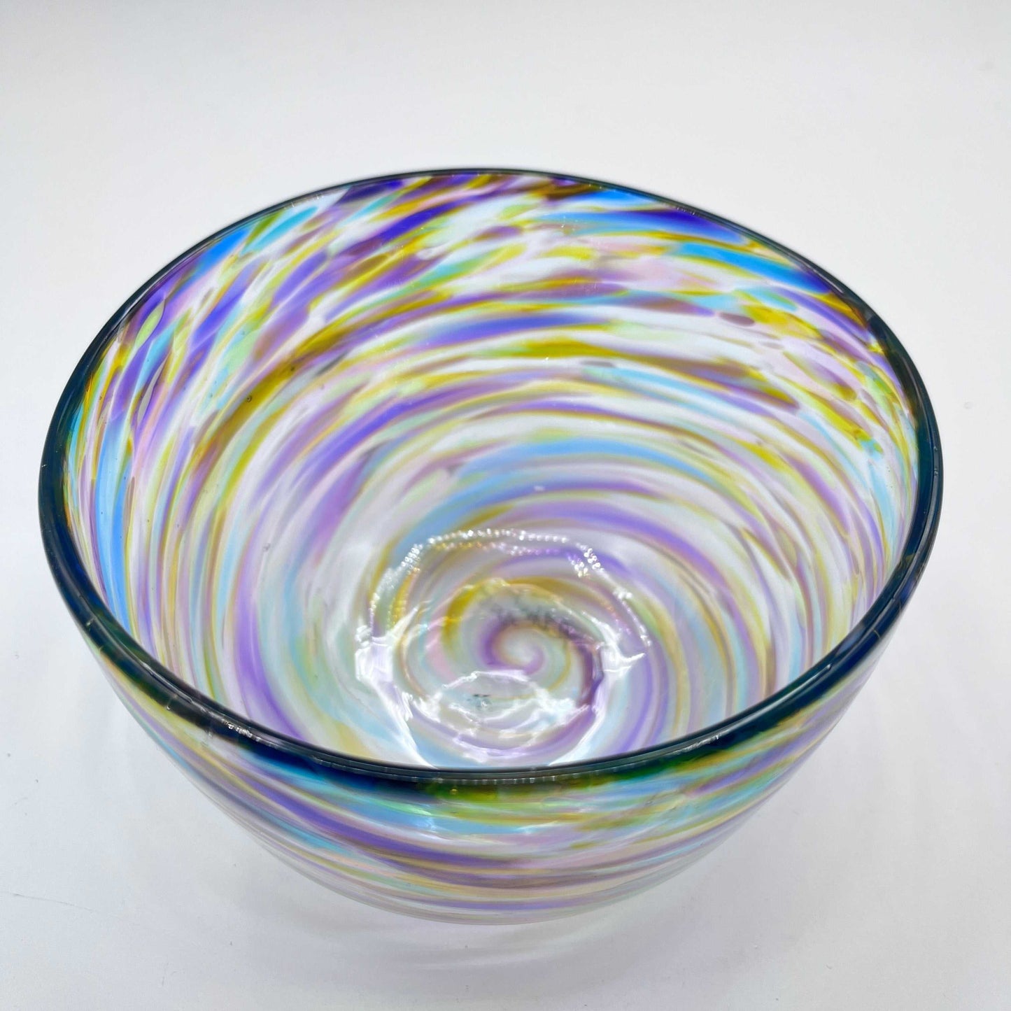 Colorful fruity blown glass bowl with swirling sunset-inspired hues and organic twist design