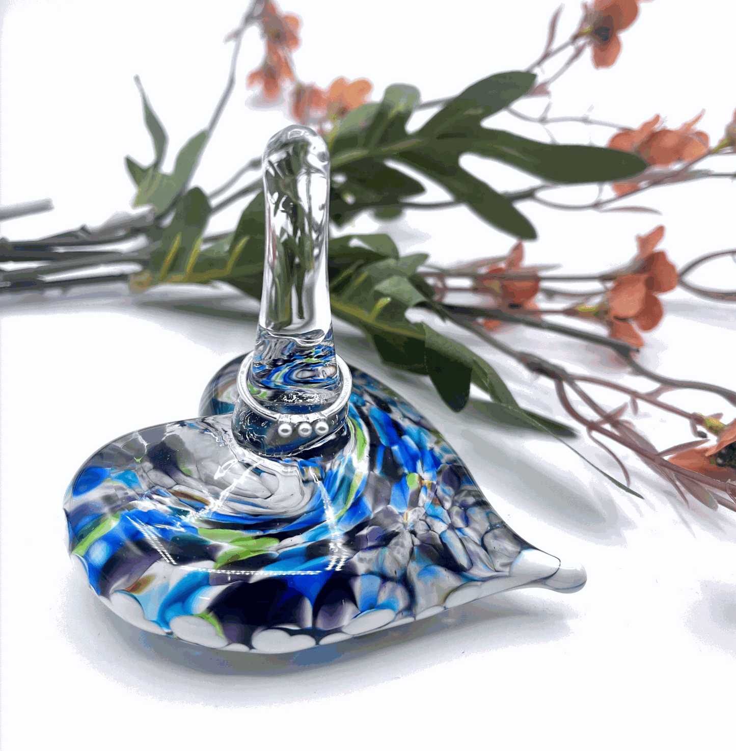 Hand-blown glass heart ring stand with blue jewel tones and elegant swirls for jewelry display