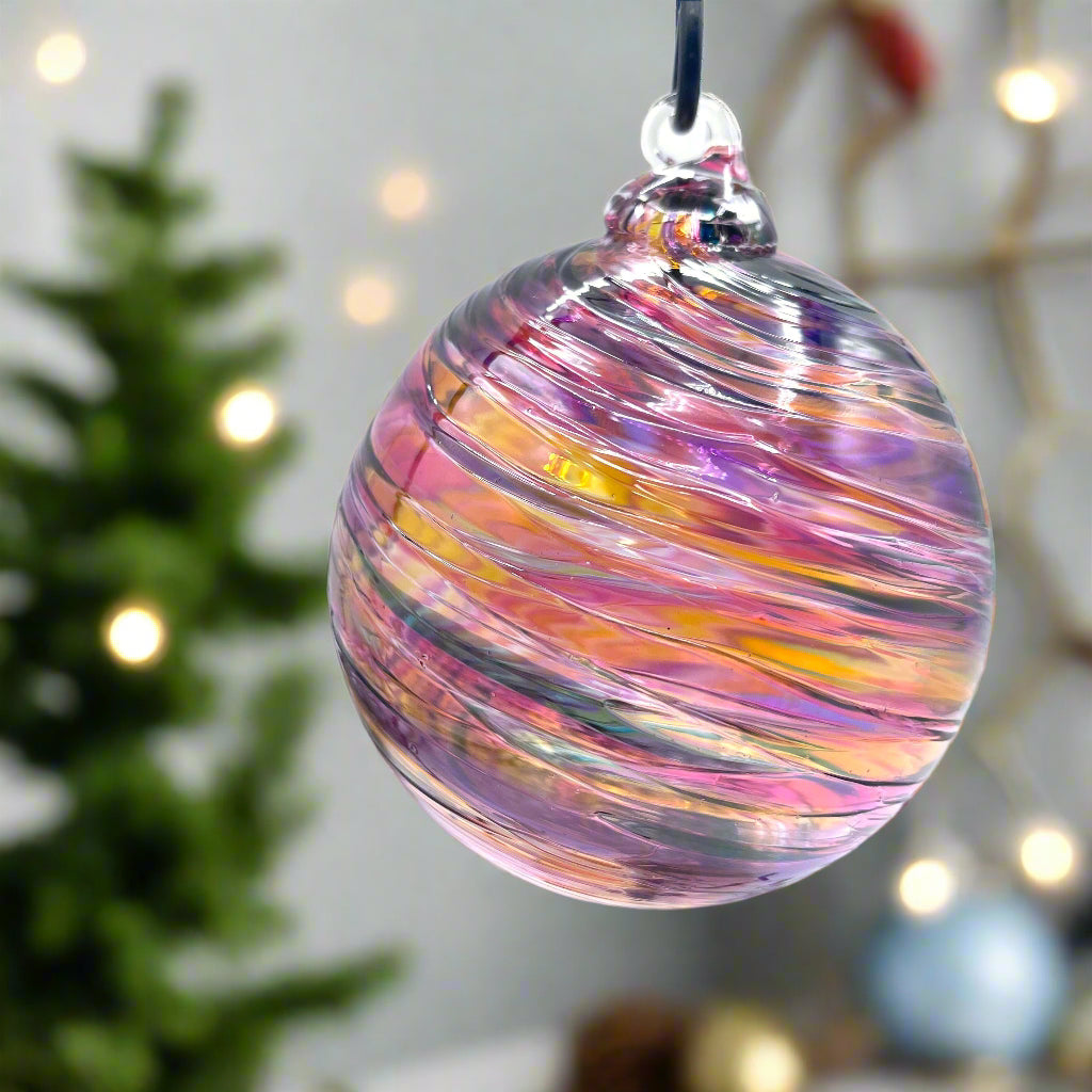 Hand blown Sunset Spiral Twist glass ornament with colorful spiral design, 4x4 inches, perfect for gifts and year-round decoration.