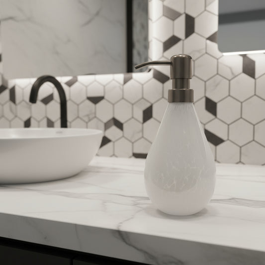 White soap dispenser with a metallic pump on a white platform against a light gray background