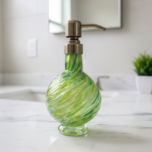 Marbled glass soap dispenser in emerald and olive with hand-blown texture and brass pump