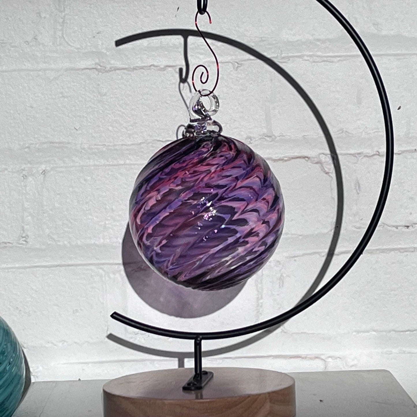 Purple Mix Spiral Twist hand blown glass ornament with spiral design hanging on stand
