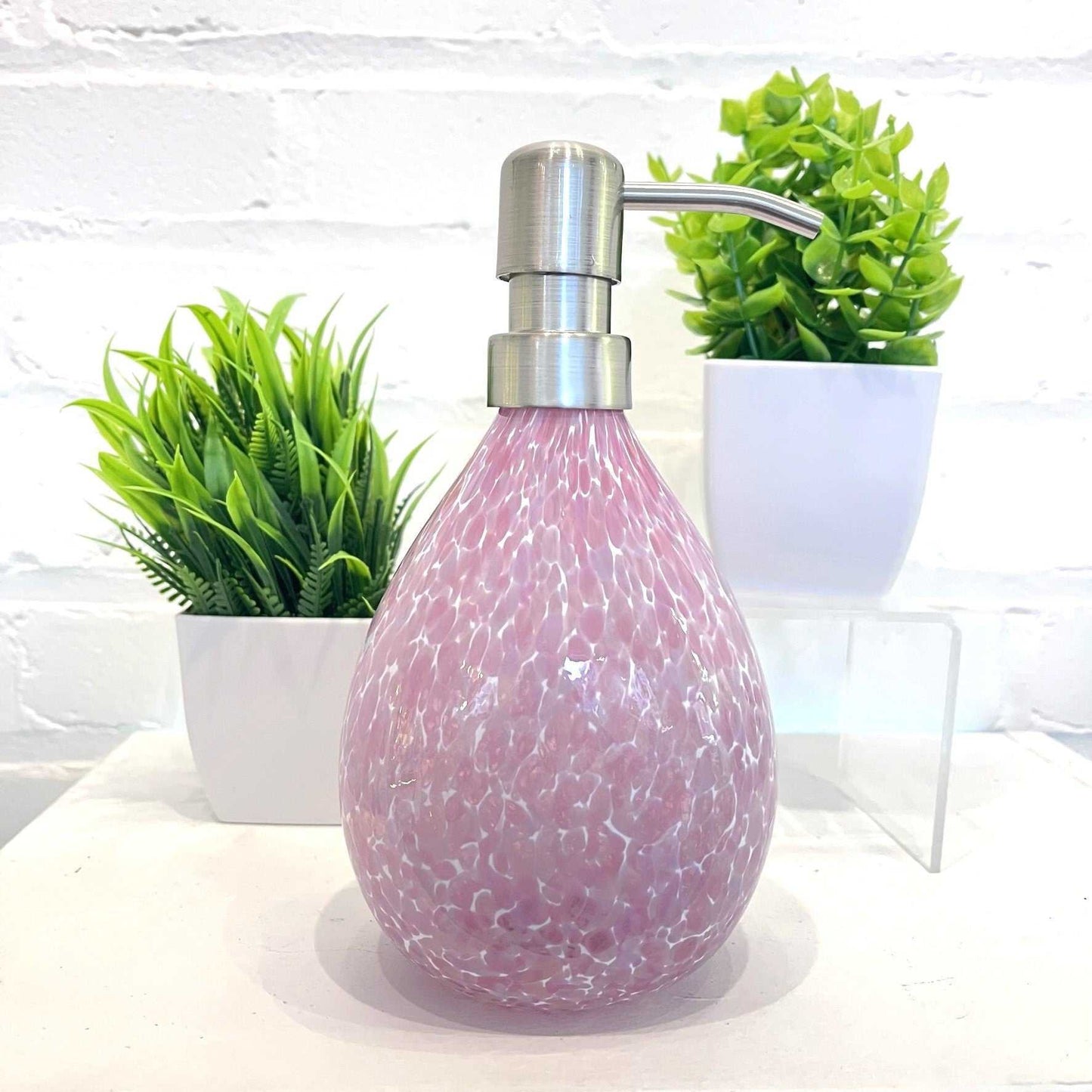 Pink hand blown glass soap dispenser with stainless steel pump and speckled design