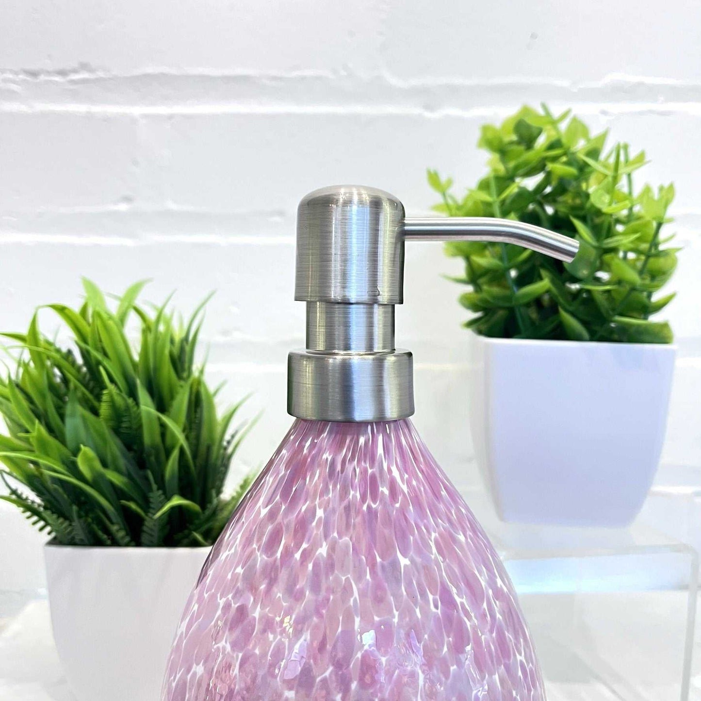Pink hand blown glass soap dispenser with stainless steel pump and speckled design