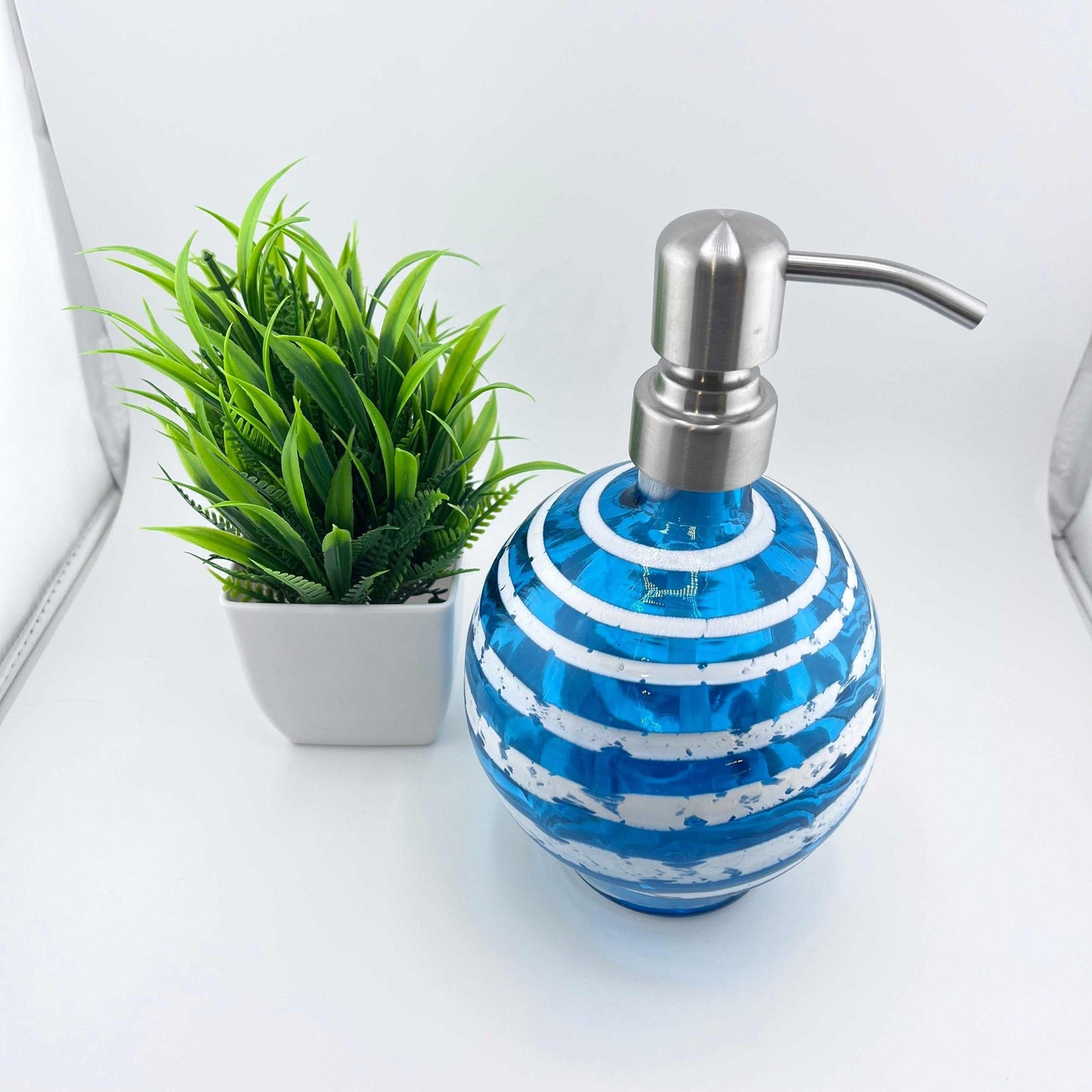 Boho handblown glass soap dispenser in aqua blue with white spiral and stainless steel pump