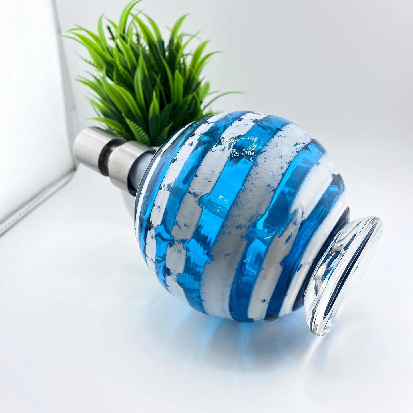 Boho handblown glass soap dispenser in aqua blue with distressed white spiral design and metal pump top.