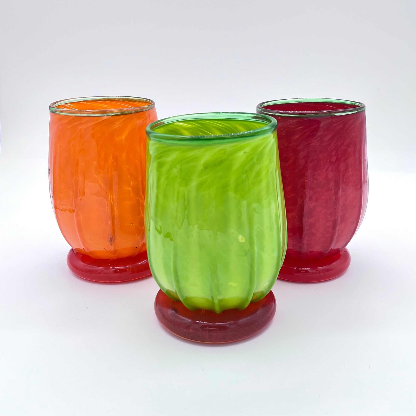 Colorful hand blown Gourdy Glasses with applied foot and colored lip wrap in orange, green, and red, stemless wine glasses made in Rhode Island.