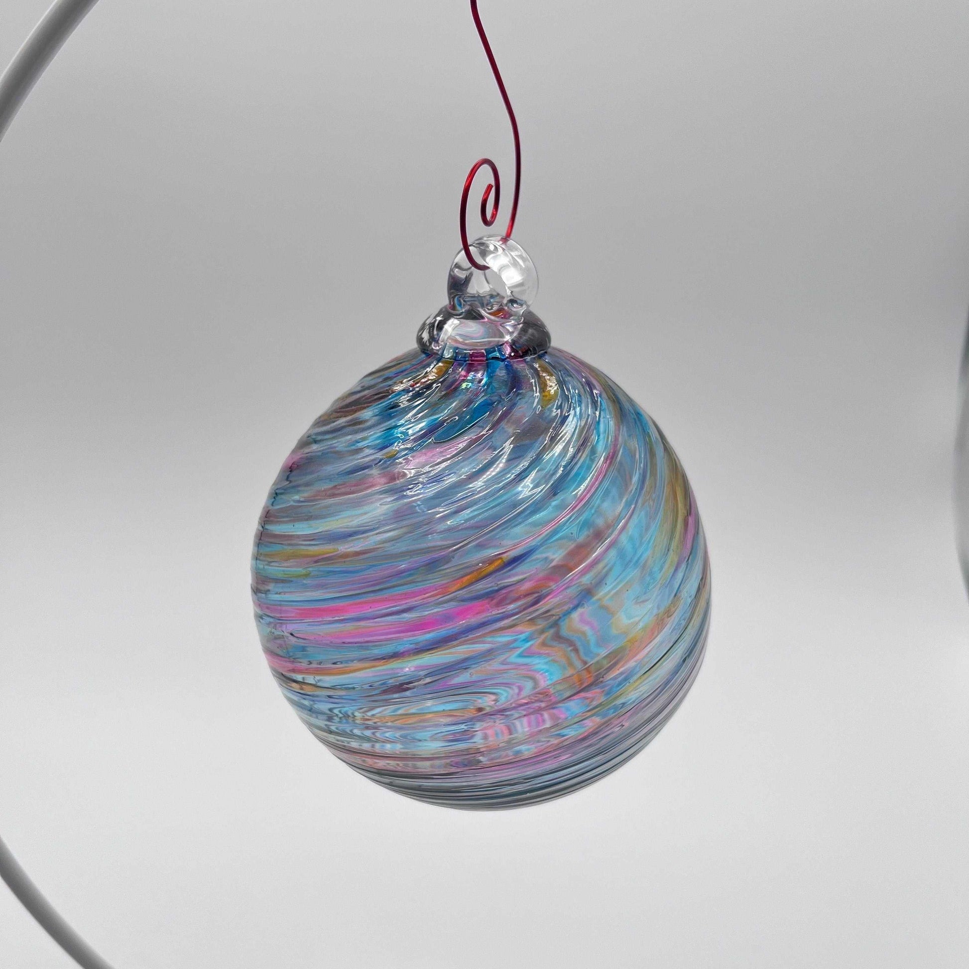 Hand blown glass holiday ornament with bluesy spiral twist design, 4x4 inches, hanging decoration