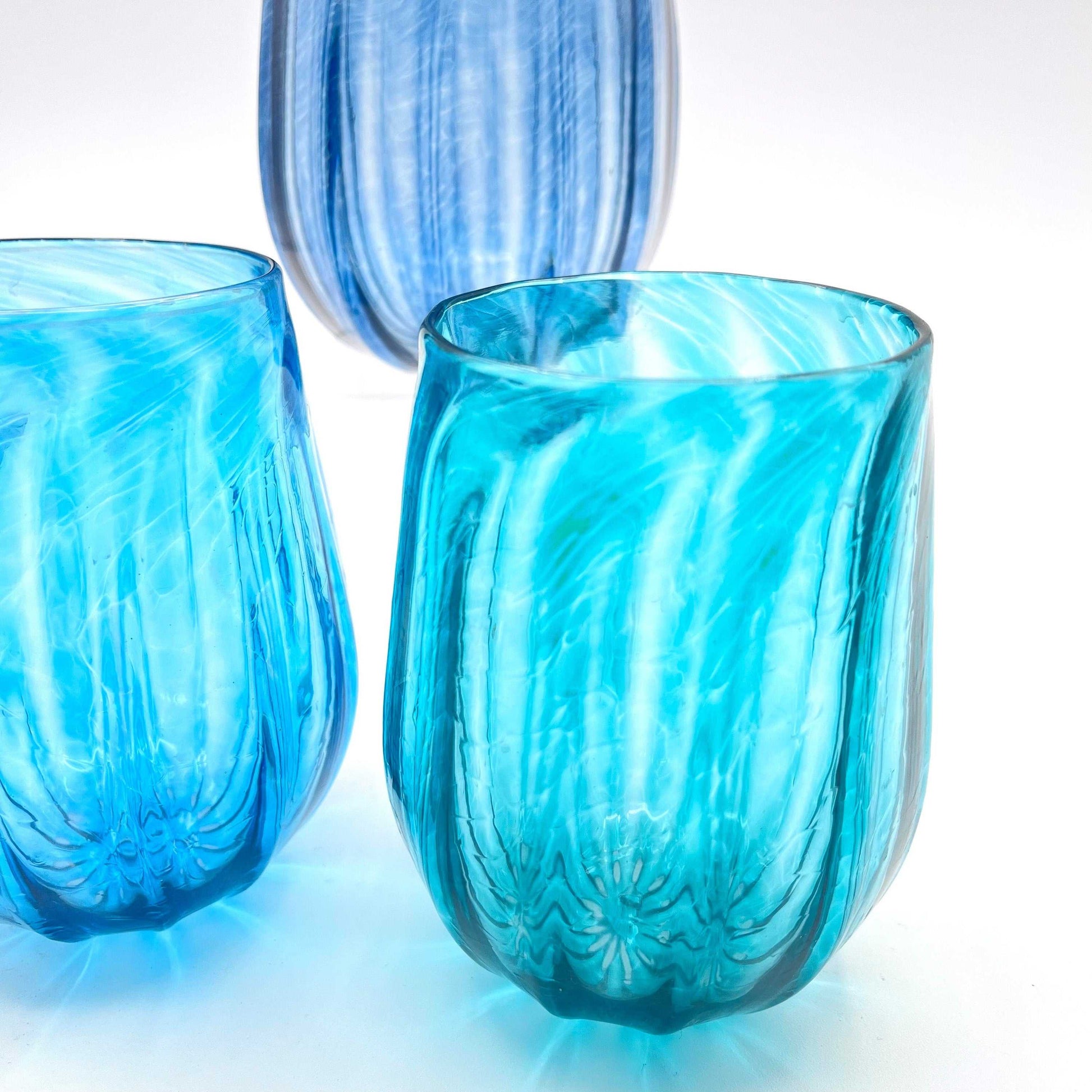 Hand blown blue stemless wine glasses with textured design and applied foot, made in Rhode Island.