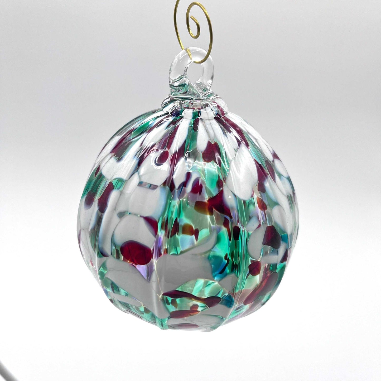 Holiday hand blown glass ornament with multicolor pattern and gold swirl hanger, 4x4 inches, handcrafted decorative bauble
