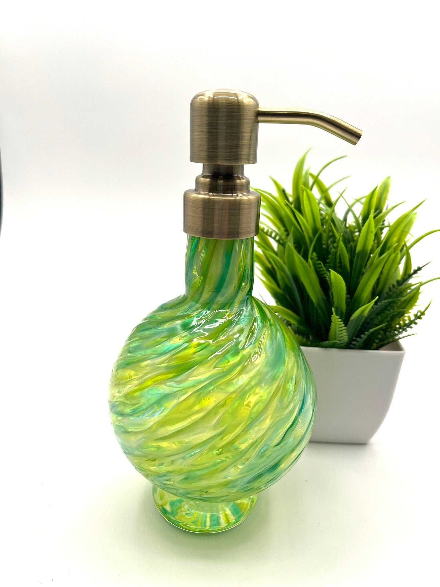 Marbled glass soap dispenser in emerald and olive with hand-blown texture and brass pump