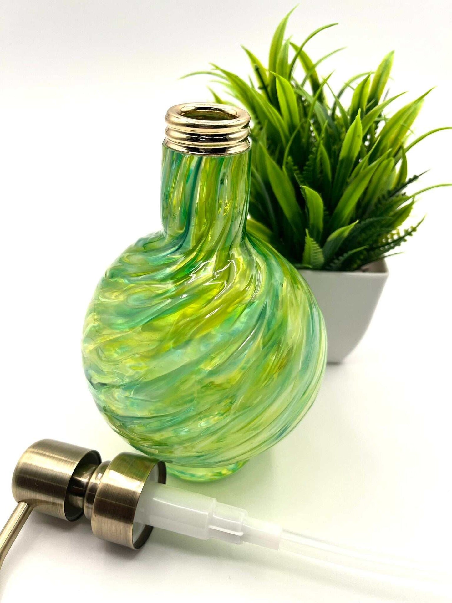Handcrafted marbled glass vanity set in emerald and olive with soap dispenser, bowl, and glass, featuring a textured swirl design