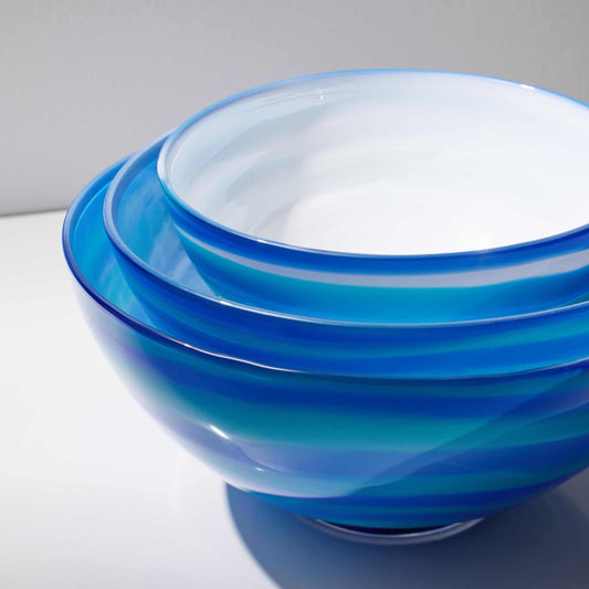 Hand blown glass blue ocean wave bowl with opal white interior and clear glass foot, available in three sizes