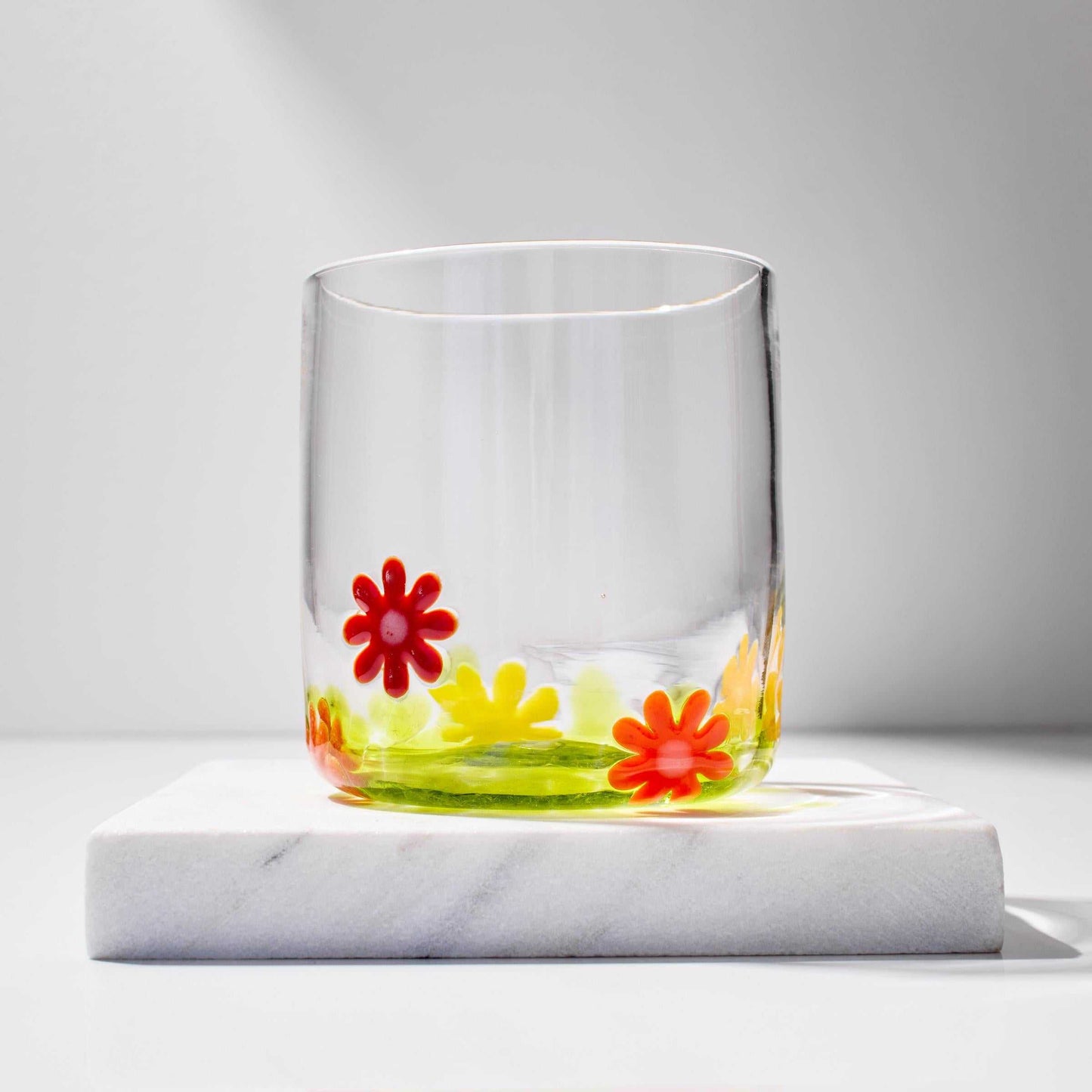 Hand blown whiskey glass with colorful flower design, 12 oz capacity, artisan crafted in Rhode Island