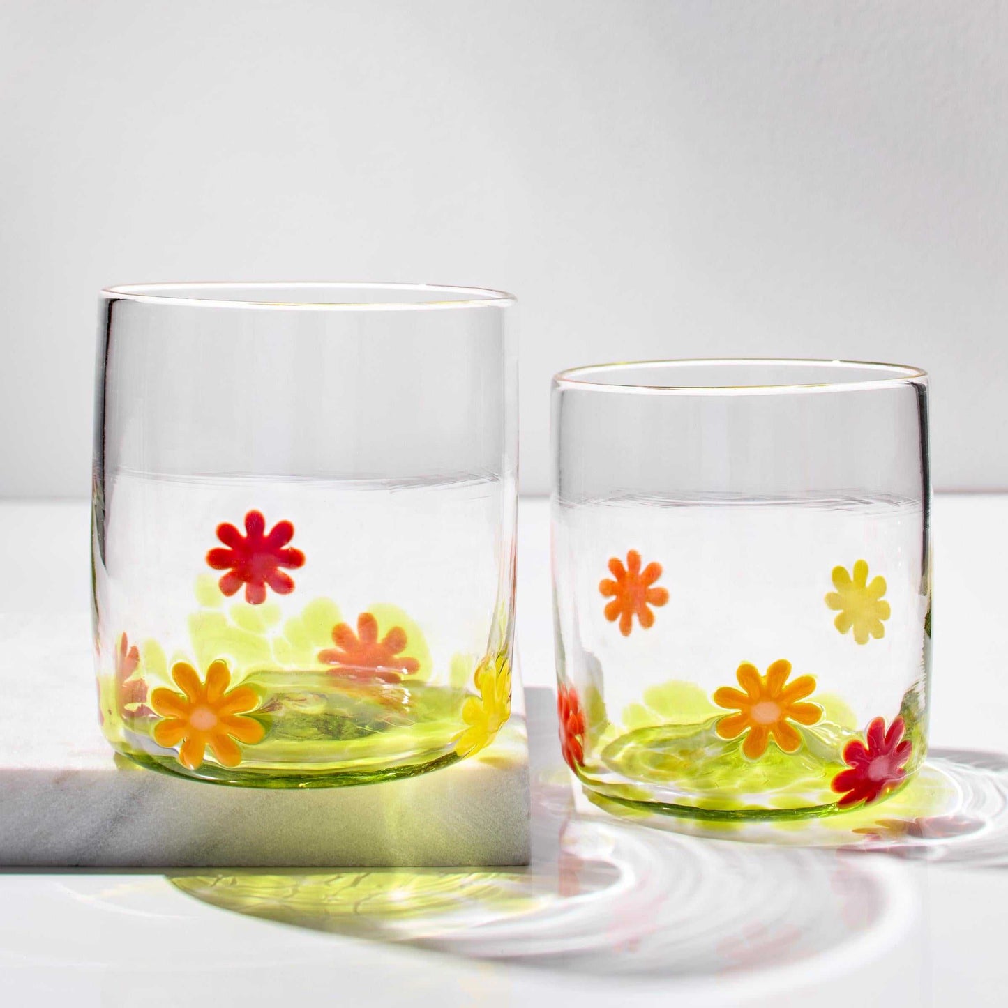 Set of hand blown whiskey glasses with colorful flower power design, made in Rhode Island.