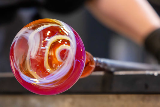 Close-up of molten glass at end of blowing pipe for 20" glory hole rental glasswork session