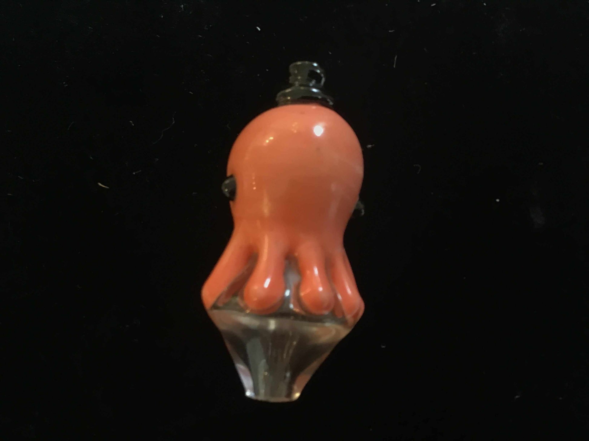Octo carb glass carb cap shaped like an orange octopus on black background