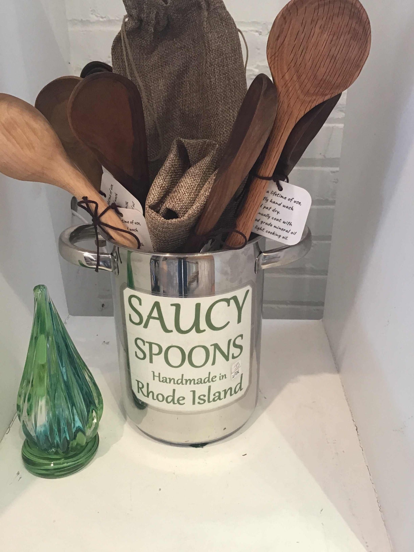 Saucy Spoons wooden cooking spoons set in a metal container labeled Handmade in Rhode Island