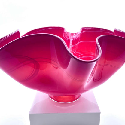 Pink twisted glass bowl with fluid, organic curves made from hot glass