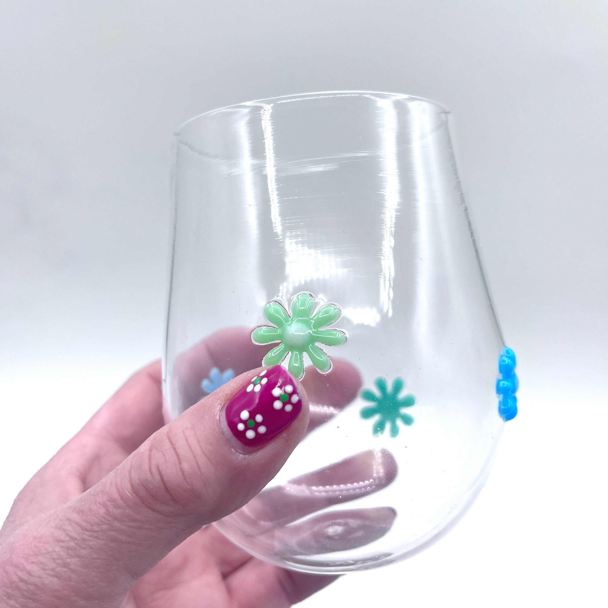 Hand blown stemless wine glass with colorful retro flower decorations, 12 oz capacity, unique artisan-made design