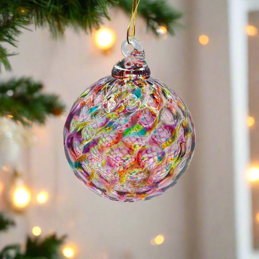 Colorful hand-blown glass ornament with intricate rainbow swirls, ideal for holiday decoration or gifting