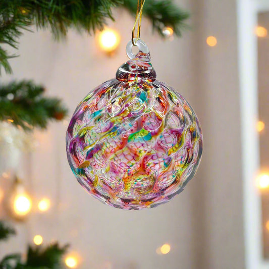 Colorful hand-blown glass ornament with intricate rainbow swirls, ideal for holiday decoration or gifting