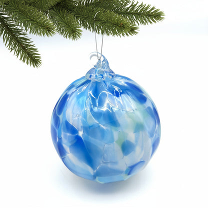 Blue glass ornament on a white background