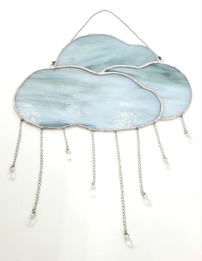 Decorative cloud-shaped object with chains on a white background