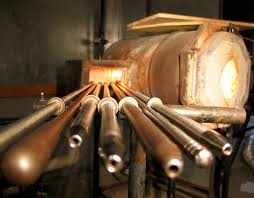 Set of glassblowing tools including pipes and puntys near a furnace for shaping molten glass Pipes Punty's