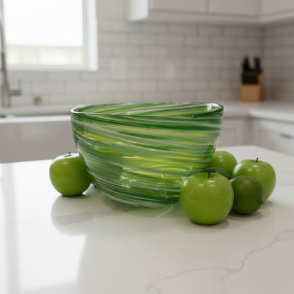 Green glass bowl on a white pedestal against a gray background