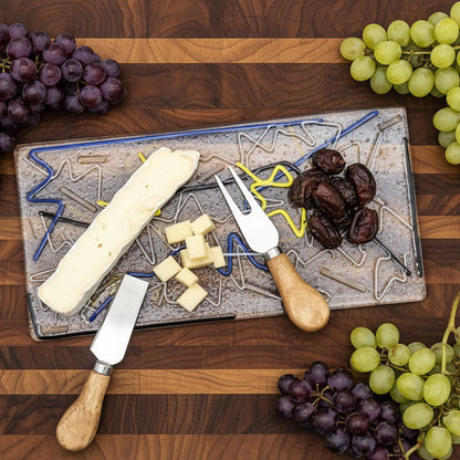 Choose Your Own Fusing Project fused glass cheeseboard with cheese, almonds, and spreader knives.