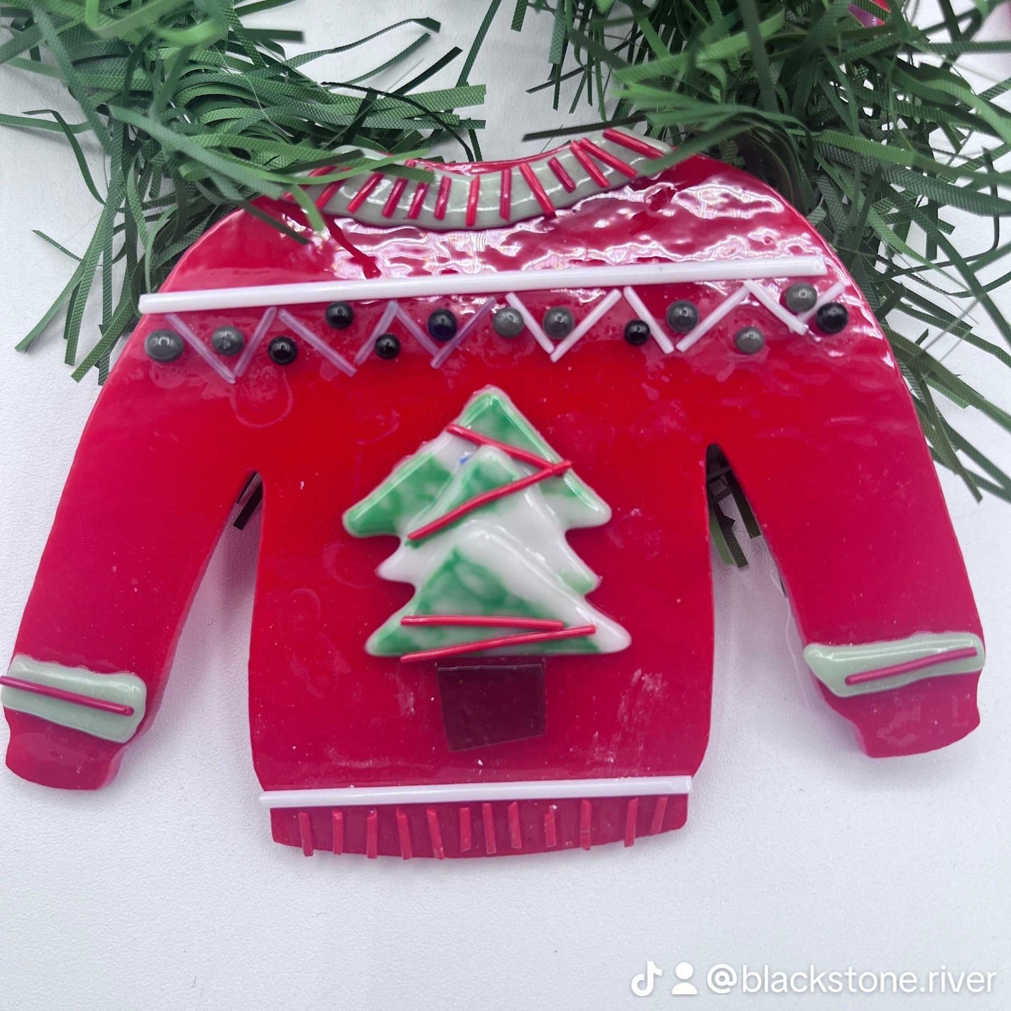 Red fused glass sweater ornament with green Christmas tree design for private group glass experience at Blackstone River Glass Center