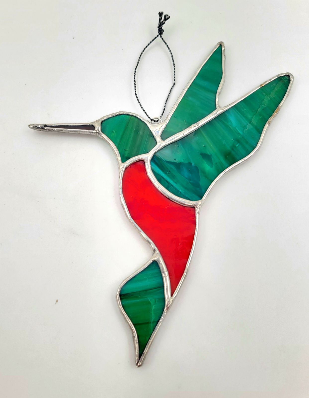 Stained glass hummingbird ornament on a white background