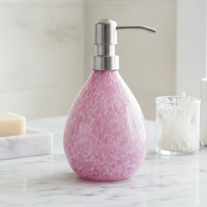 Pink hand blown glass soap dispenser with stainless steel pump and speckled design, 12-ounce capacity.